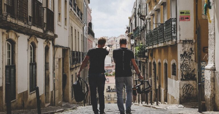 Two Man Walking in Between of Buildings Toward With Concrete Building