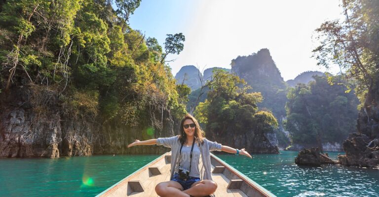 Photo of Woman Sitting on Boat Spreading Her Arms