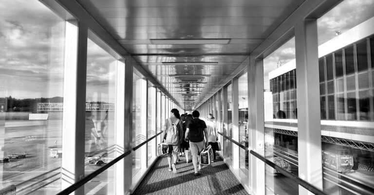 Person Carrying Bag Walking on Path Way