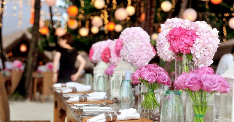 Table With Plates and Flowers Filed Neatly Selective Focus Photography