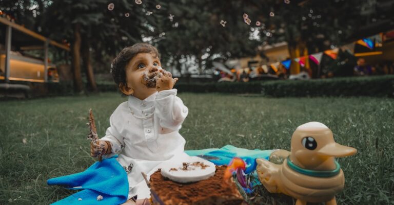 cute baby eating cake at garden