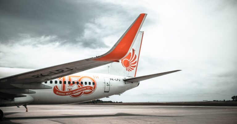 Parked White and Orange Airplane