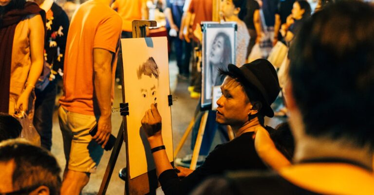 Man in a black t shirt and hat sketching