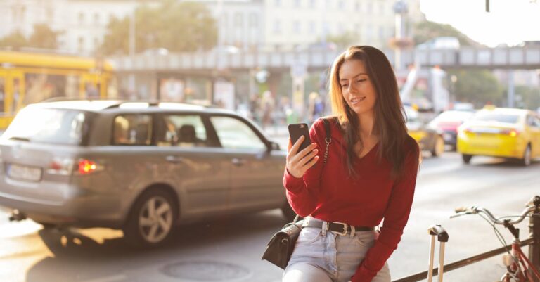 Woman in Red Long Sleeve Shirt and Blue Denim Pants Sitting Metal Realing