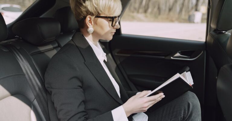 Focused woman checking planner information in car