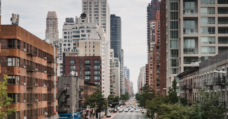 New Your City street with vast busy road between contemporary typical buildings on clear day