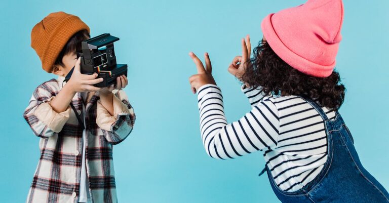 Positive diverse children taking photo on instant photo camera