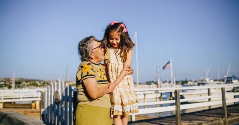 Grandma with Her Granddaughter Standing on the Shore