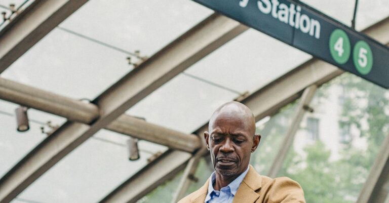 Man Looking At His Watch On A Subway Station