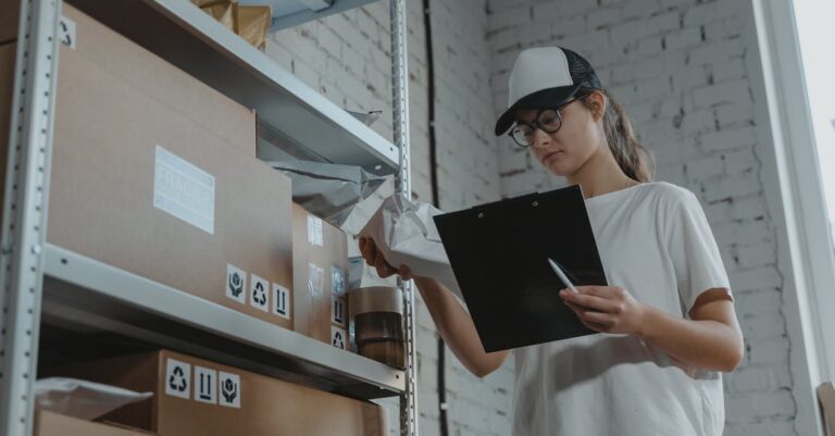 Woman in White T-shirt Holding Black Laptop Computer