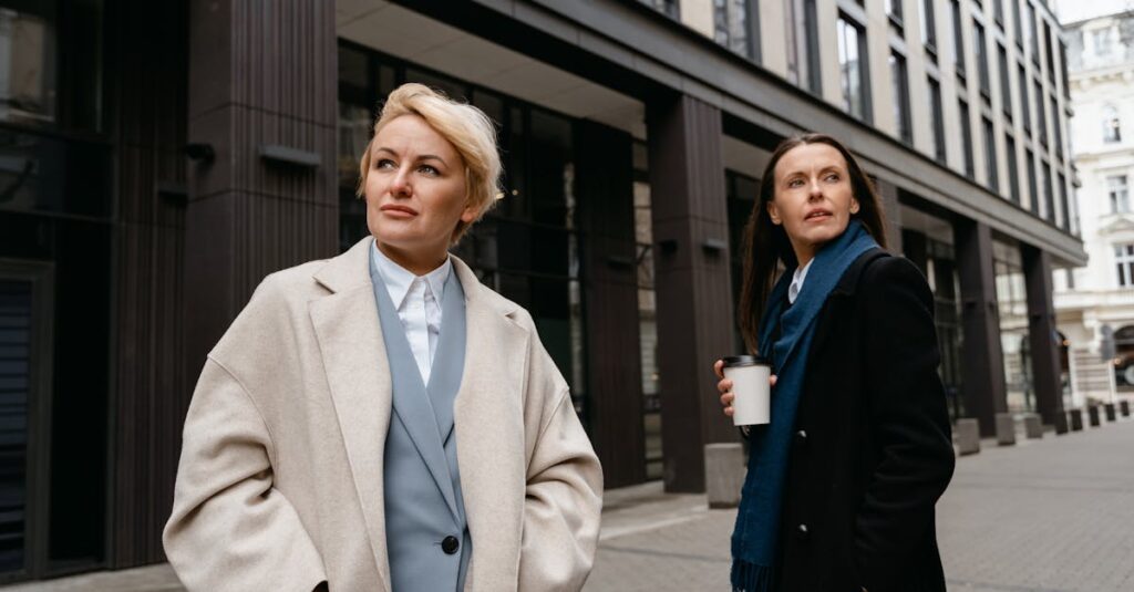 Woman in Beige Coat Standing Near Building