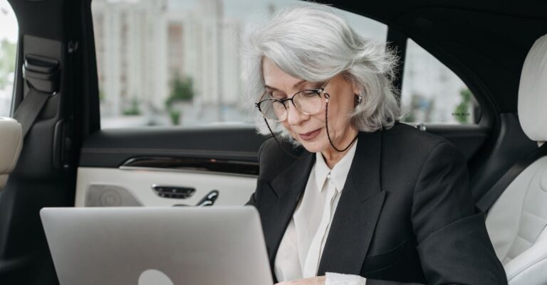 An Elderly Woman Working inside a Car