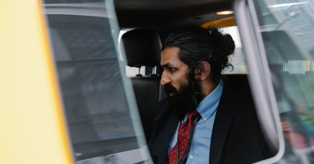 Man in Suit sitting inside Car