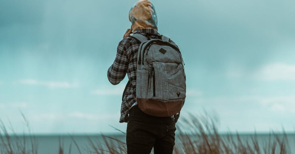 A man with a backpack enjoys a serene oceanside view in Atlantic City, New Jersey.