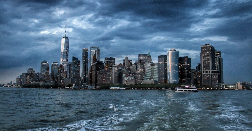 Dramatic view of New York City skyscrapers against a moody twilight sky.