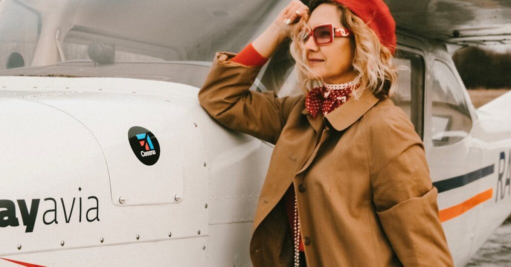 Stylish woman in sunglasses and red beret posing by airplane outdoors.