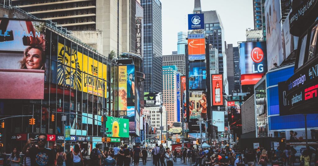 Bustling daytime view of Times Square with crowds, skyscrapers, and iconic billboards in New York City.