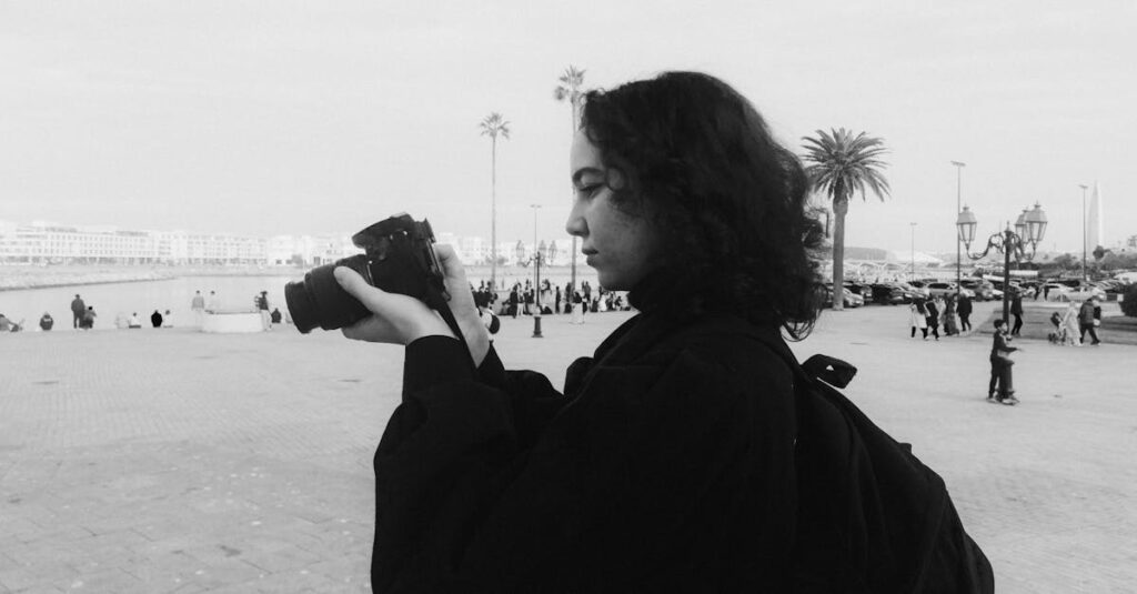 A candid black and white photo of a photographer capturing a Moroccan cityscape.