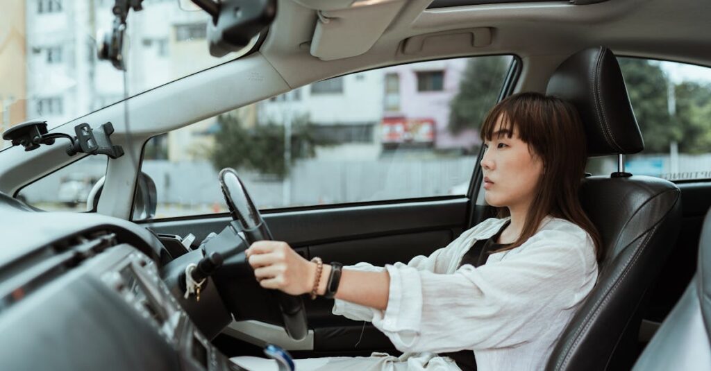 Confident young woman driving in the city, focused and pensive.