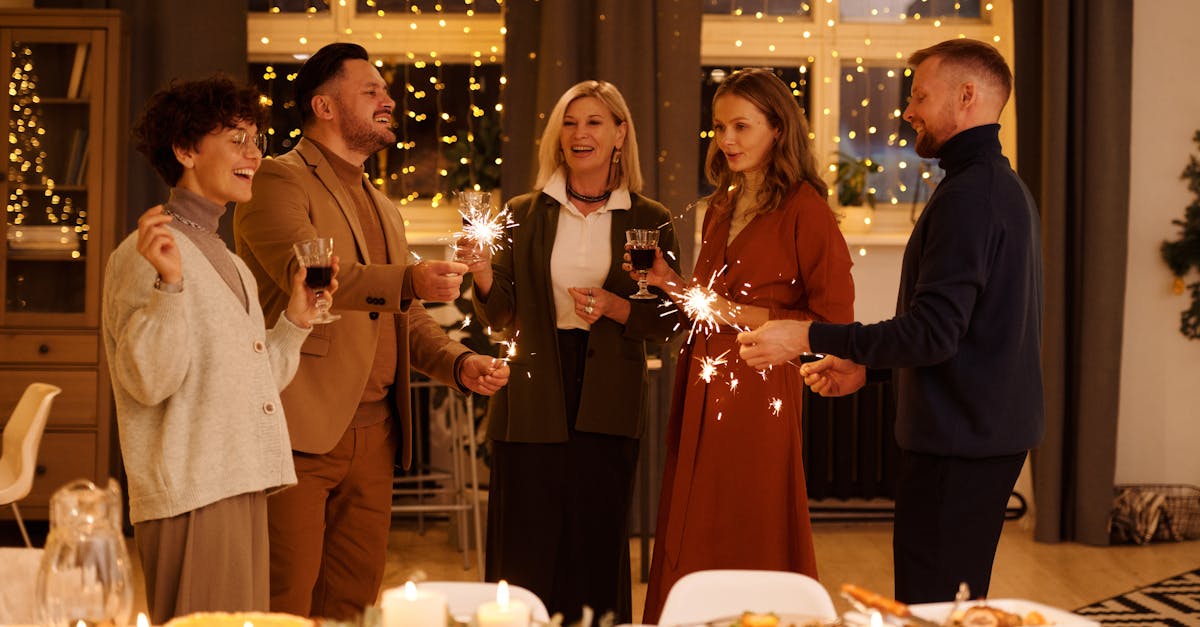 A joyful gathering of adults celebrating the holiday season indoors with sparklers.